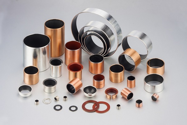 Cast bronze bushings with solid lubricant inserts
