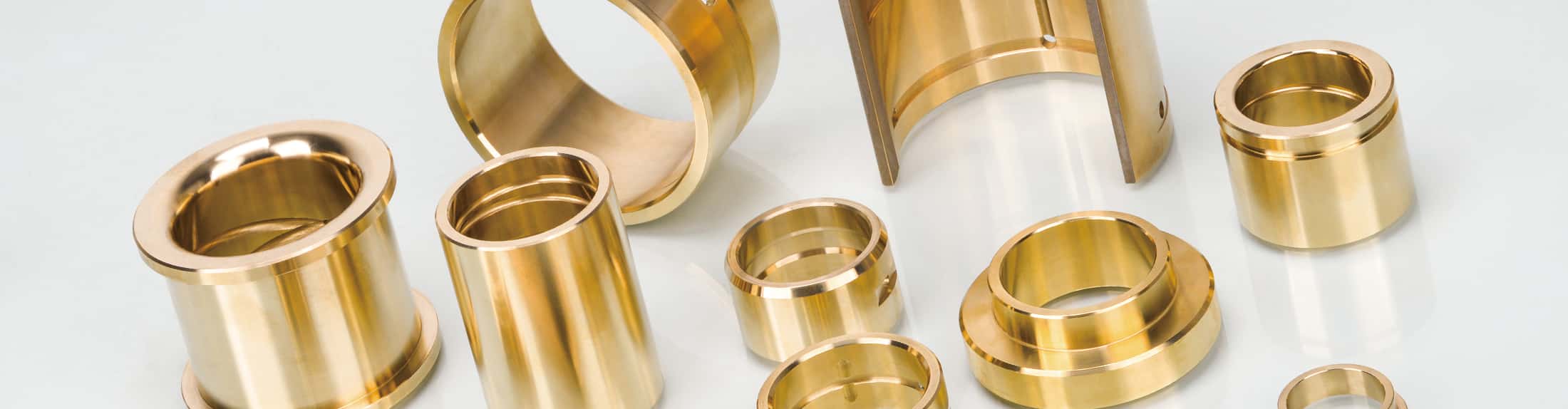 Cast bronze bushings with solid lubricant inserts